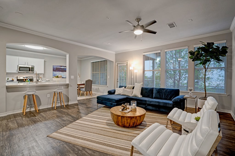 a living room with a couch and a ceiling fan