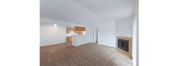 A living room with a fireplace and a white wall.