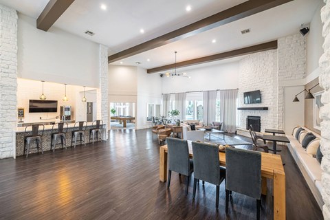 A modern living room with a fireplace and a dining table set up.