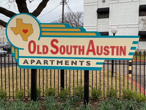 a sign for old south in front of a fence
