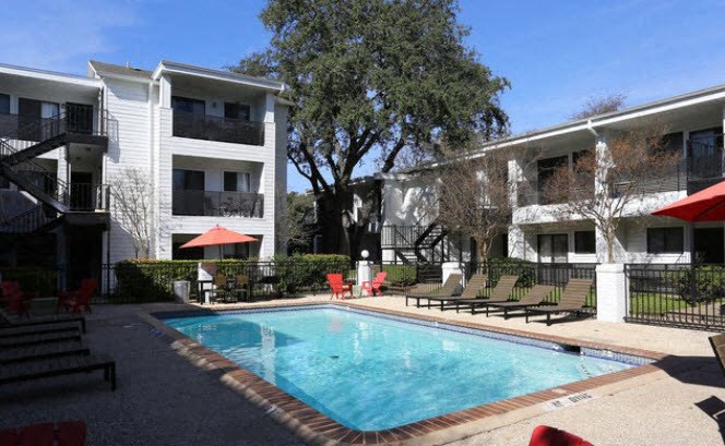 a swimming pool in front of an apartment building