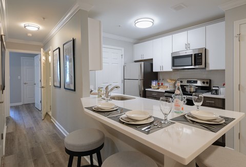 a kitchen with a large island with plates and utensils