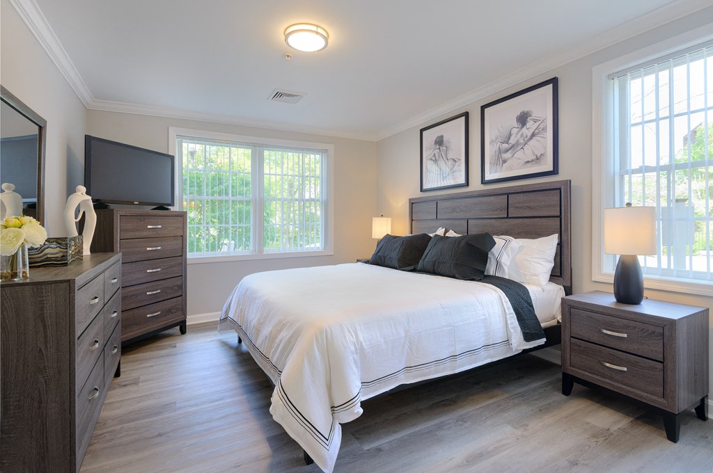 a bedroom with a bed and two dressers