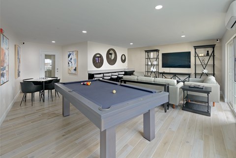 a blue pool table in a living room with couches and a television