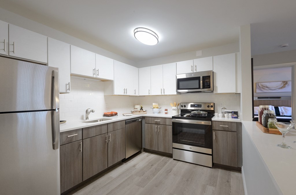 a kitchen with white cabinets and stainless steel appliances