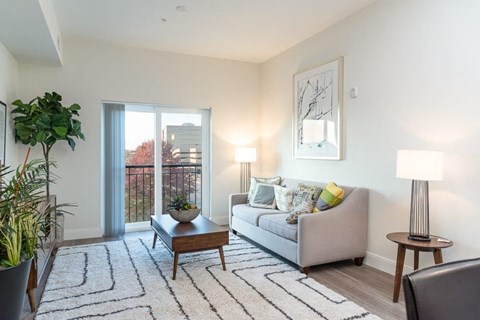 a living room with a couch and a sliding glass door