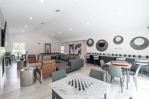 A modern living room with a checkered table in the middle.