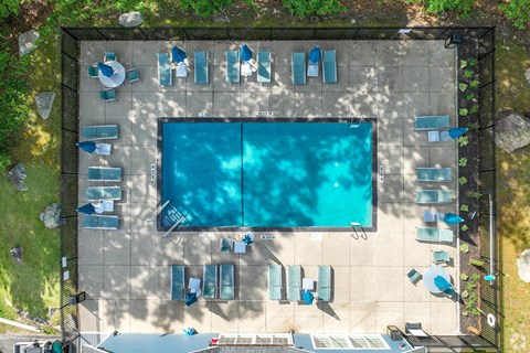 An aerial view of a swimming pool surrounded by lounge chairs.