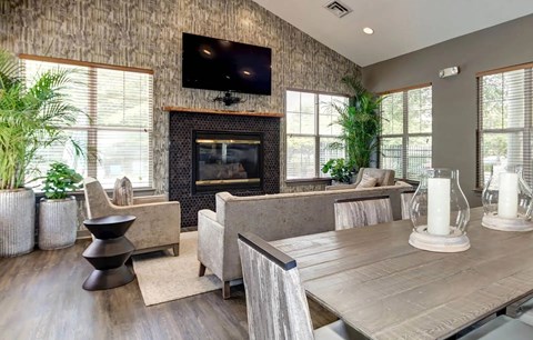 A modern living room with a fireplace and a flat screen TV mounted above it.