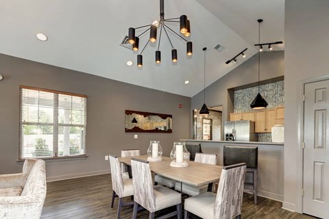 A modern dining room with a wooden table and chairs.