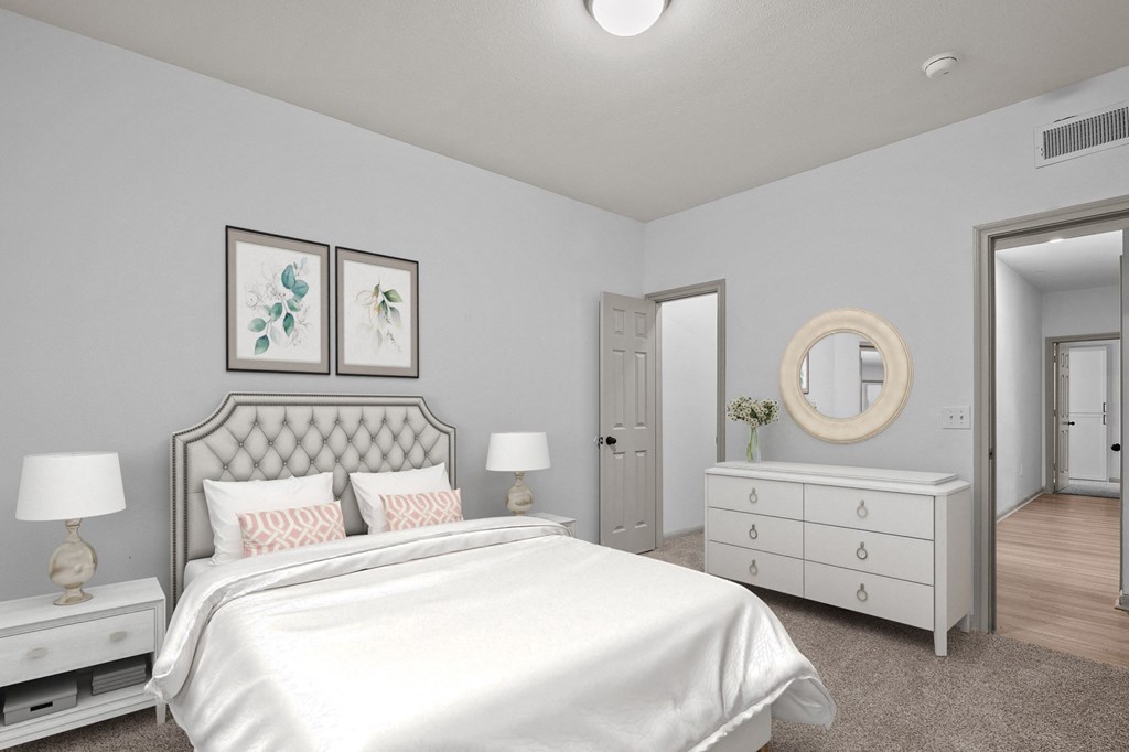 a white bedroom with a white bed and a white dresser