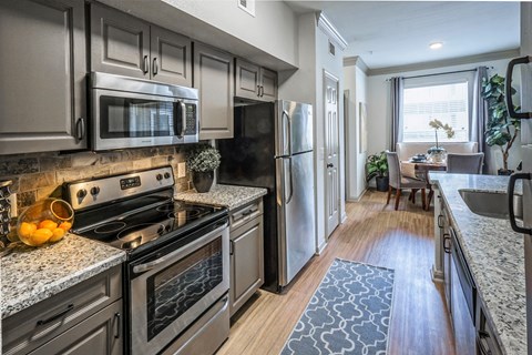 a kitchen with stainless steel appliances and granite counter tops