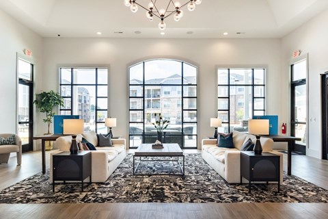 A large, well-lit room with a rug, two couches, and a coffee table.