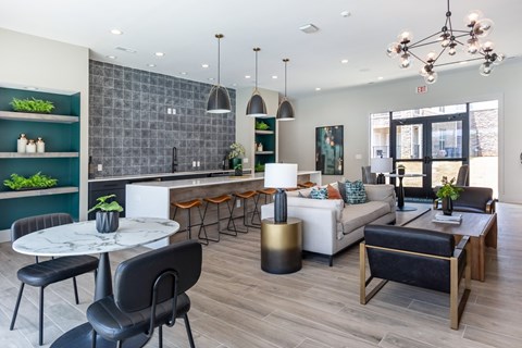 A modern living room with a dining table and chairs.