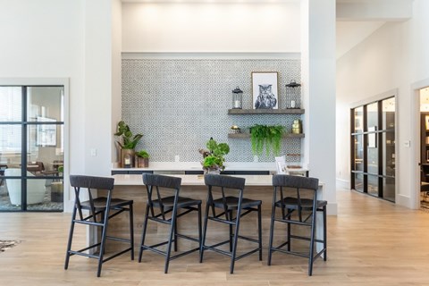 A dining room with a table and chairs.