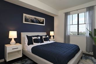 a bedroom with a bed and a blue accent wall