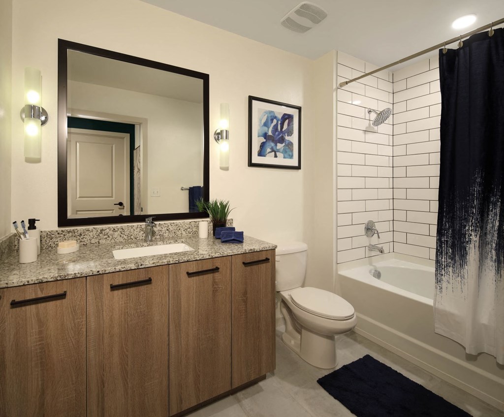Bathroom with mirror and wooden cupboard at Azola West Palm Beach, Florida