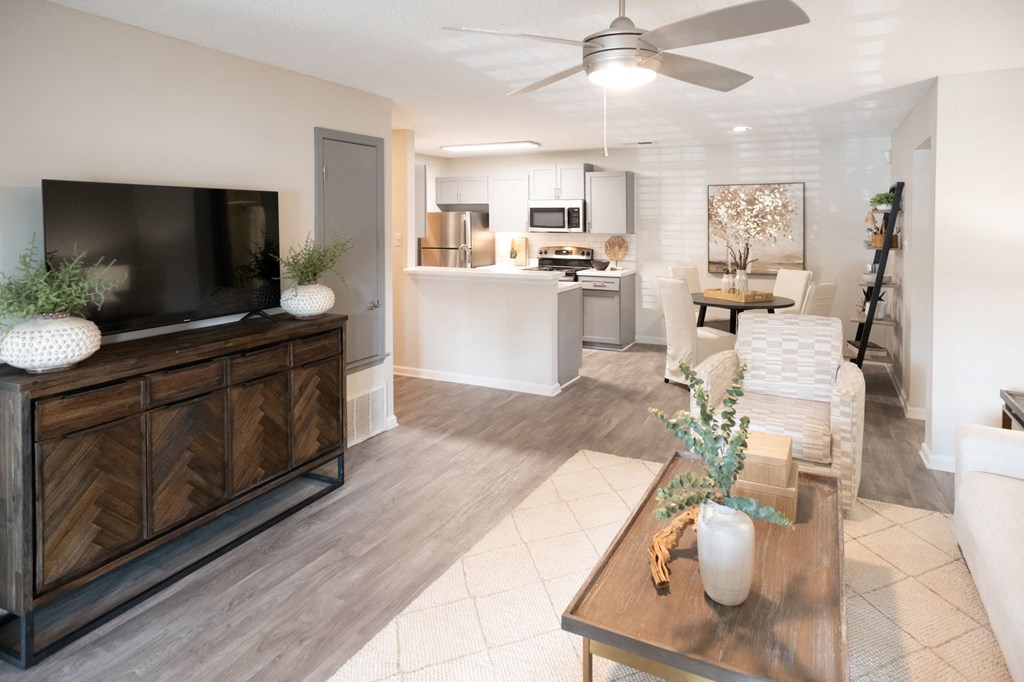 A living room with a wooden cabinet and a television on the left side. at The Addison at Collierville, Tennessee, 38017