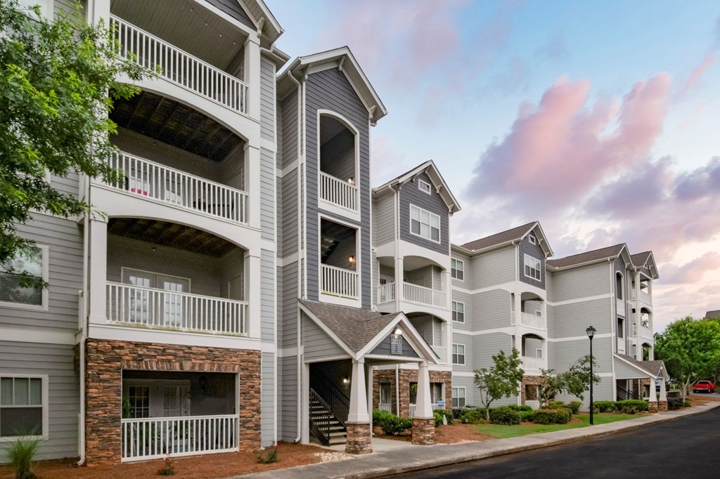 Apartment building with balconies and a stone facade at Ansley at Town Center Apartments, Evans, 30809