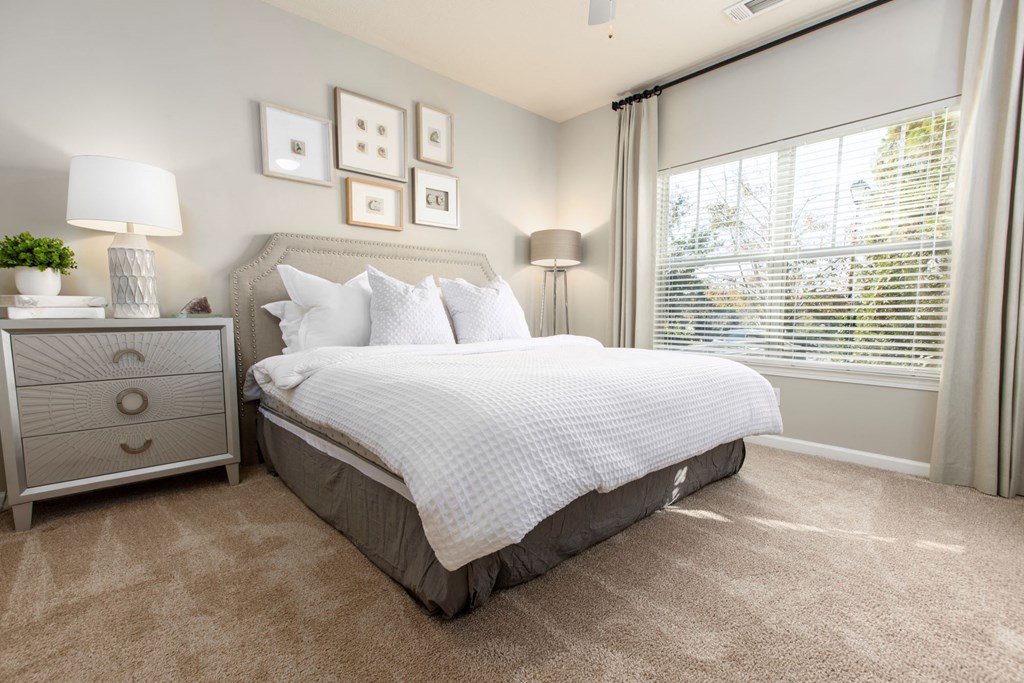 a bedroom with a bed and a window at Ansley at Town Center in Evans GA