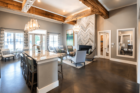 A modern kitchen with a large island and bar stools.