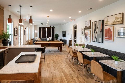 A modern kitchen and dining area with wooden floors and furniture.