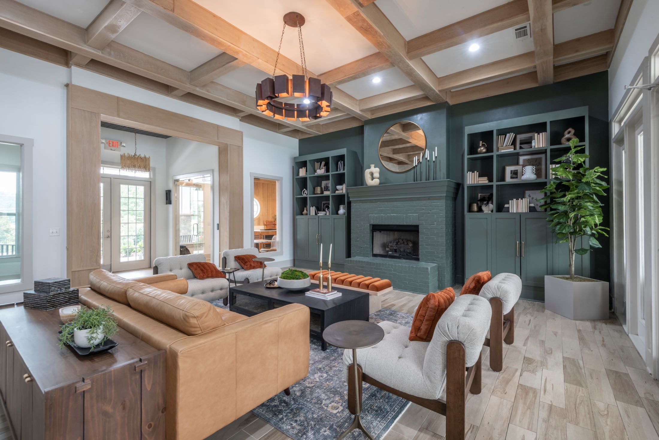 A living room with a brown sofa and a fireplace.