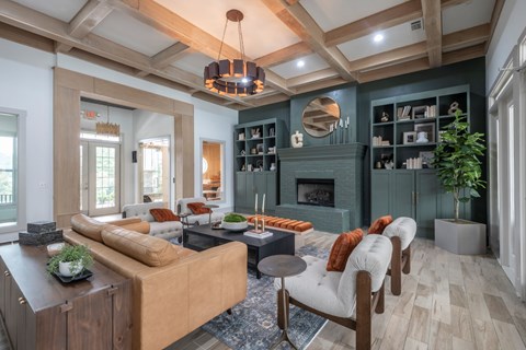 A living room with a brown sofa and a fireplace.