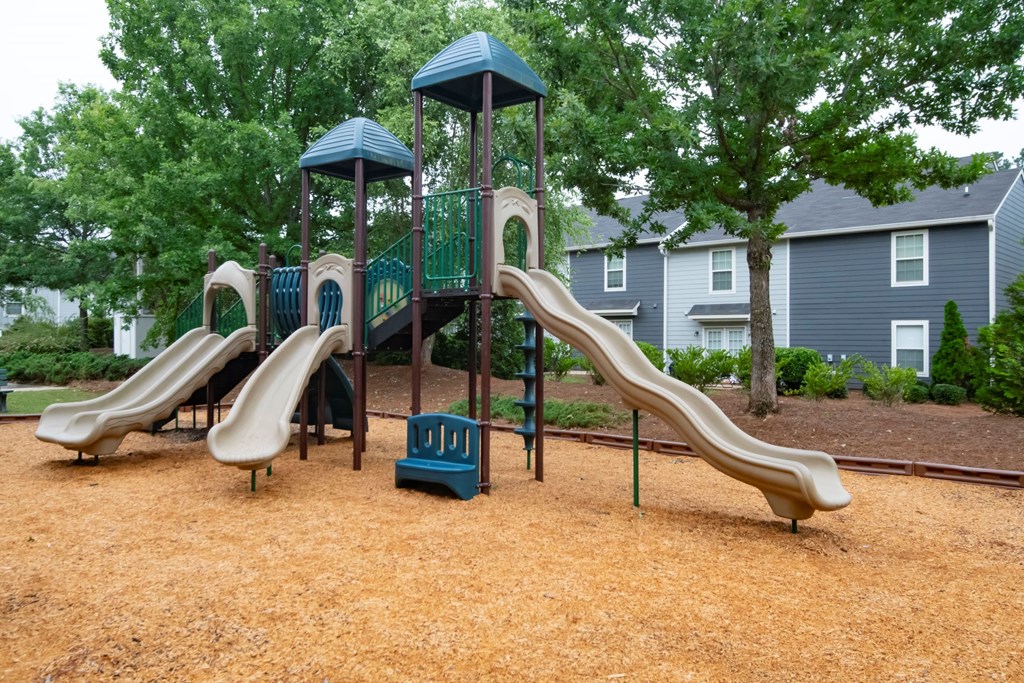 A playground with a brown slide at Ansley at Town Center Apartments, Evans, GA