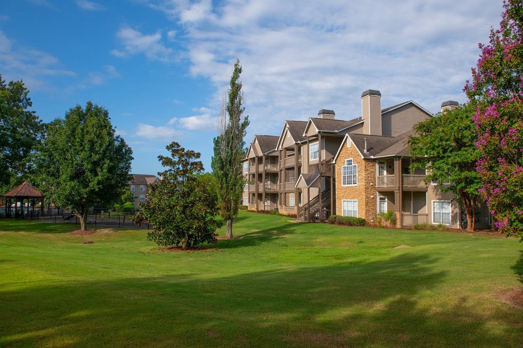 an apartment building with green grass and trees in front of it at Appling Lakes, Tennessee
