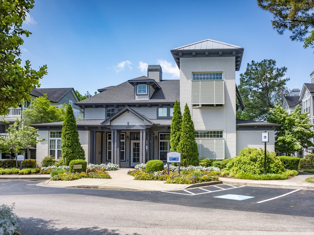 a picture of the front of a house with a parking lot in front of it