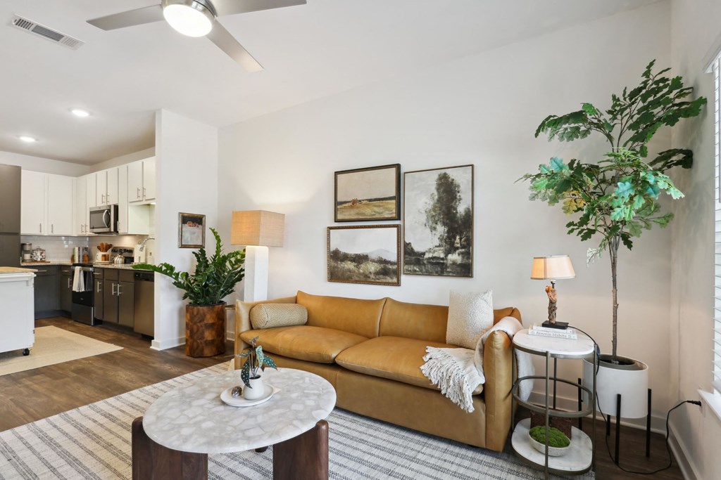 A living room with a yellow couch and a white coffee table at Arcadia Cartersville Apartments, Cartersville
