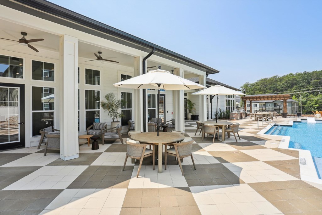 A patio with a table and chairs and an umbrella at Arcadia Cartersville Apartments, Cartersville