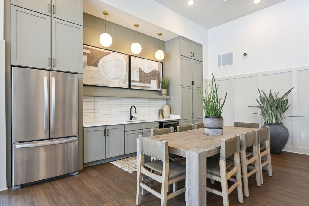 A modern kitchen with a wooden table and chairs at Arcadia Cartersville Apartments, Cartersville, Georgia