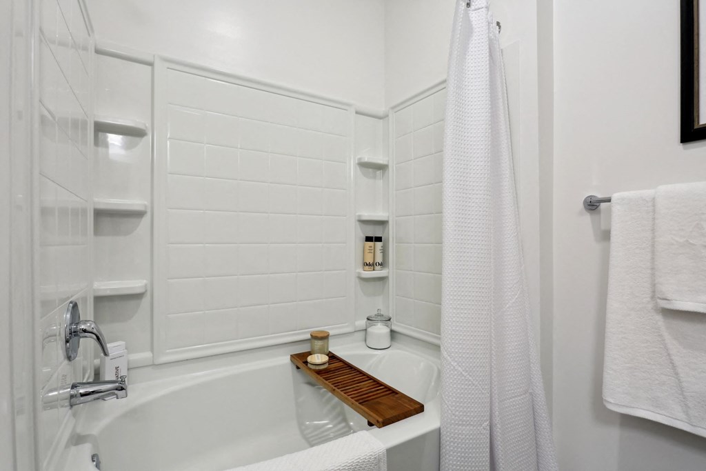 A white bathroom with a tub and a shower at Arcadia Cartersville Apartments, Georgia, 30121