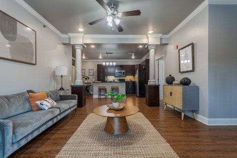 A living room with a grey couch and a wooden coffee table.