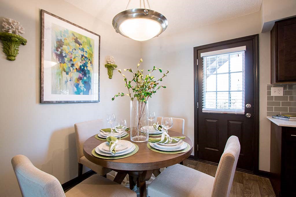 Gorgeous Dining Room Space with Elegant Lighting and Wood Plank Vinyl Flooring at Artesian East Village, Atlanta, GA 30316