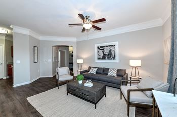 a living room with furniture and a ceiling fan  at Artesian on Westheimer, Houston, 77077