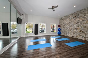 a yoga room with blue yoga mats and a rock wall at Artesian on Westheimer at Artesian on Westheimer, Houston, Texas