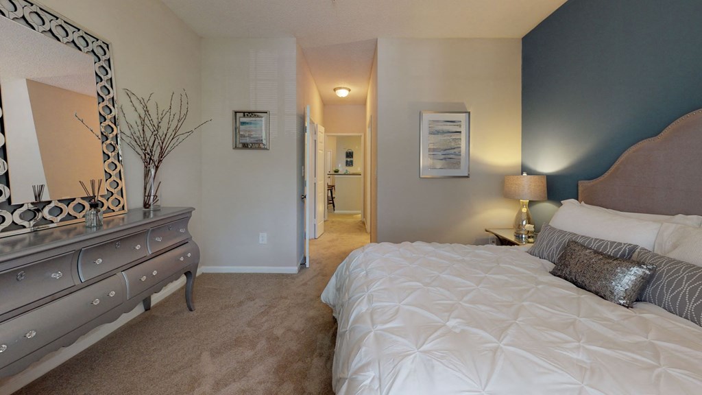 a bedroom with a bed and a dresser at Autumn Park Apartments, Charlotte, North Carolina
