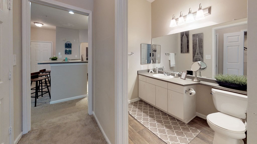 a bathroom with a toilet sink and mirror at Autumn Park Apartments, Charlotte, NC