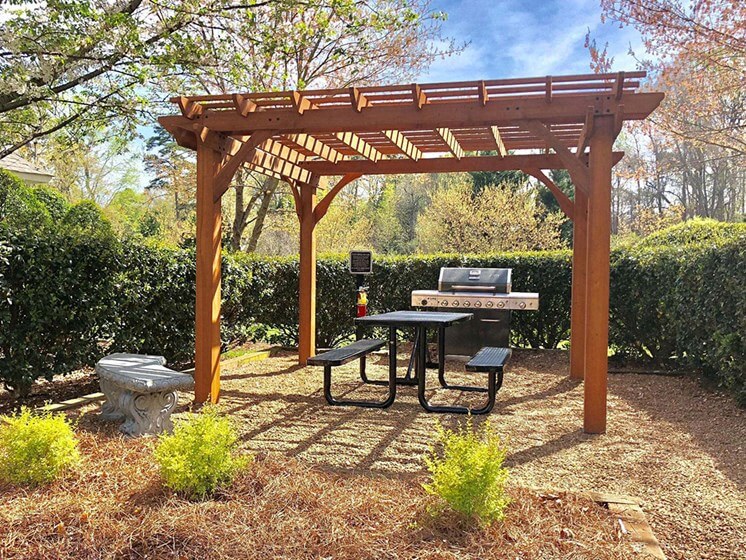 Trellised Outdoor Social & Picnic Areas surrounded by lush landscaping at Autumn Park Apartments, Charlotte, NC 28262