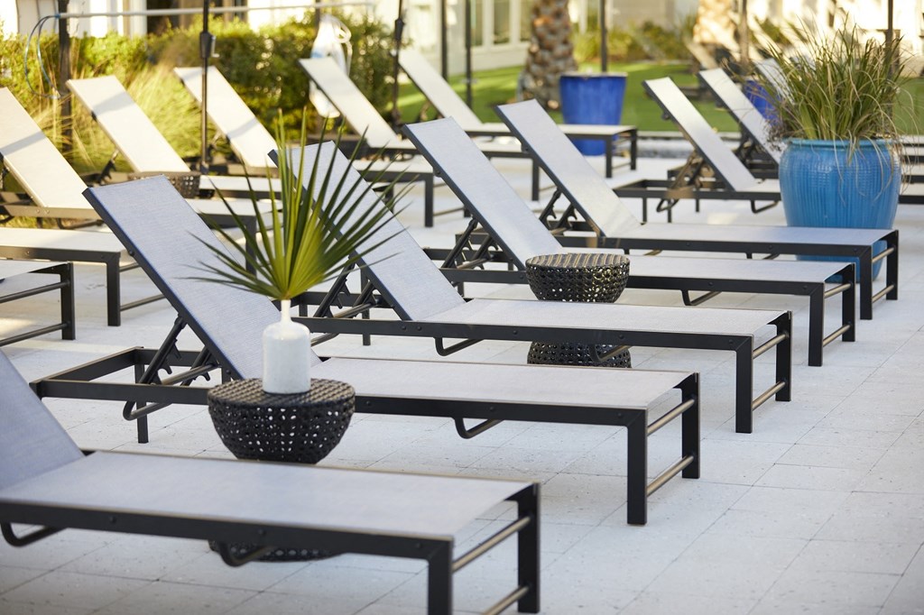 a row of lounge chairs and tables in an outdoor seating area at Livano Avondale, Avondale Arizona