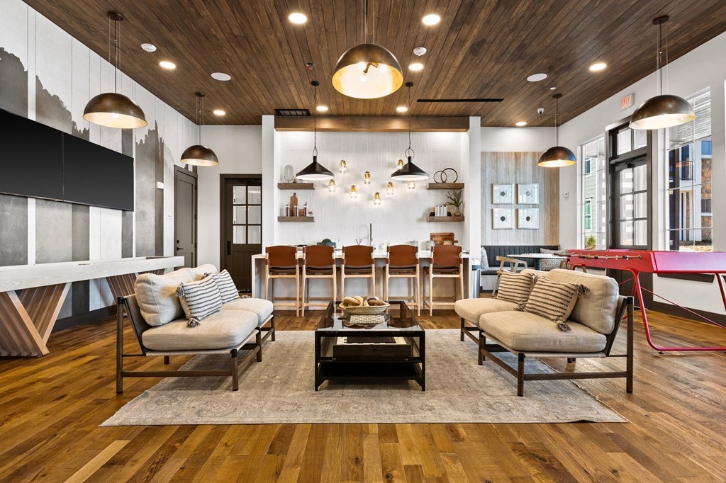 a living room with couches and chairs and a table