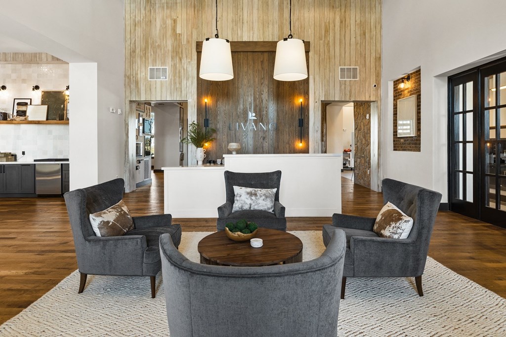 a living room with chairs and a table