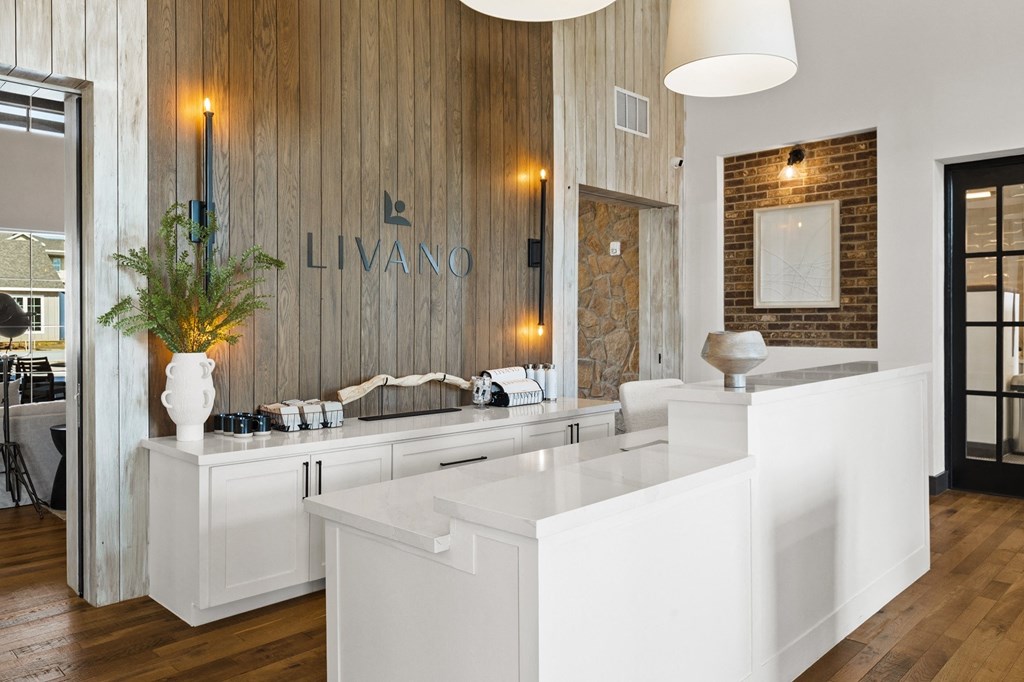 a large white counter top in a bathroom with a large mirror