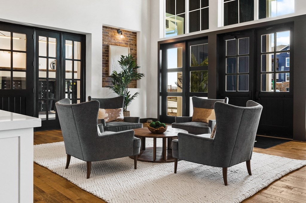 a living room with two chairs and a table