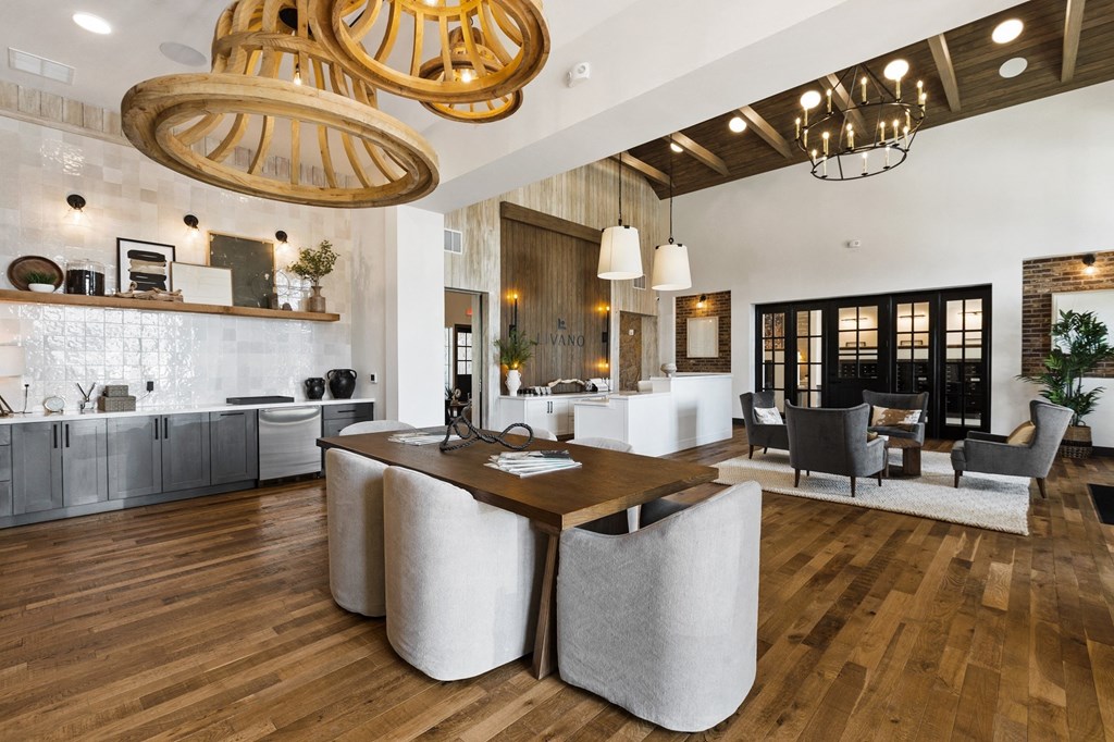 a large living room with a dining table and a kitchen