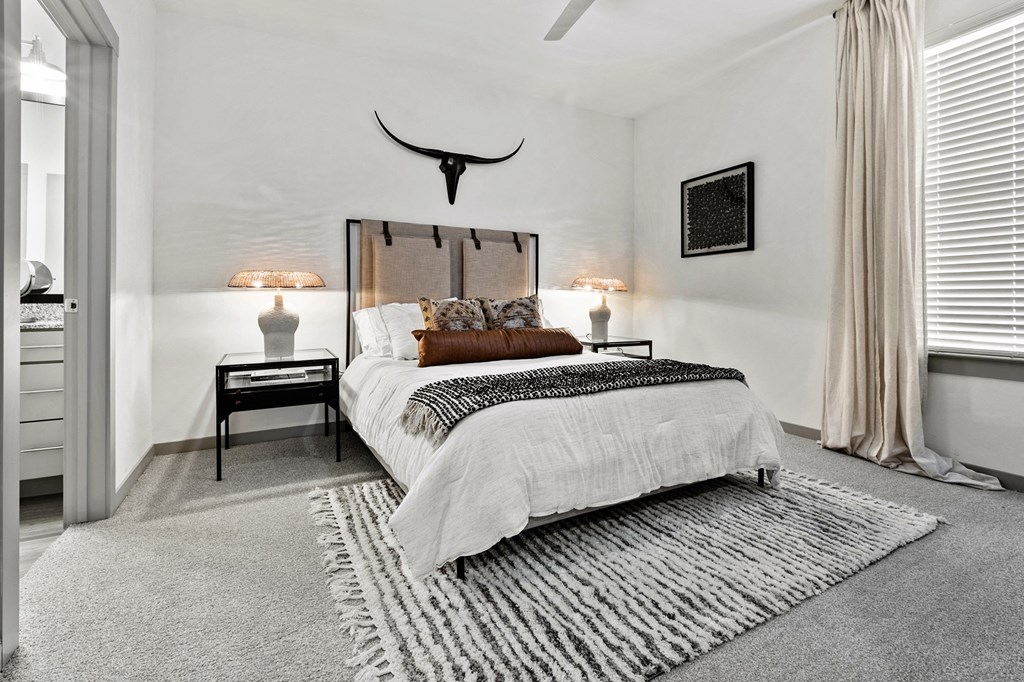 a bedroom with a bed and a skull on the wall