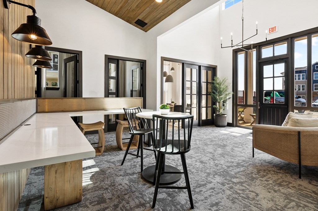 a living room with a table and chairs and a kitchen